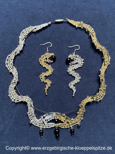 geklöppelter Schlangenschmuck (Detail) / Bobbin lace snake jewellery (detail)